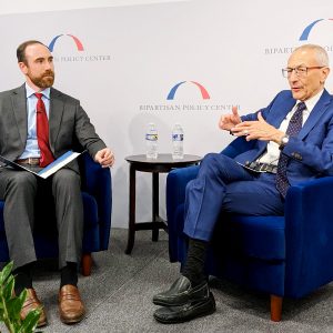 White House Senior Advisor John Podesta (right) talks about permitting reform with Xan Fishman of the Bipartisan Policy Center.