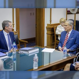 Vistra CEO Jim Burke (left) meets with Texas Gov. Greg Abbott.