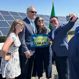 Sen. Joe Nguyễn takes a selfie with Gov. Jay Inslee, Leah Missik from Climate Solutions and Jamie Stroble from The Nature Conservancy at the bill signing ceremony in Richland, Wash.