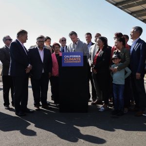 Surrounded by lawmakers, Gov. Gavin Newsom signed climate and energy legislation in September.