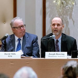 Joseph Bowring (right), president of Monitoring Analytics, speaks during the Organization of PJM States annual Market Monitoring Advisory Committee meeting on Oct. 18 while David Mills, PJM listens.