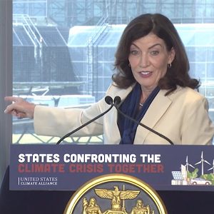 New York Gov. Kathy Hochul points to 1,400 solar panels installed on the roof of the Javits Center, the largest single rooftop array in Manhattan.