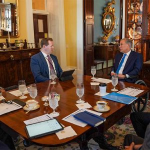 Texas Gov. Greg Abbott  (right) meets with interim ERCOT CEO Brad Jones (left), Texas PUC Chair Peter Lake.