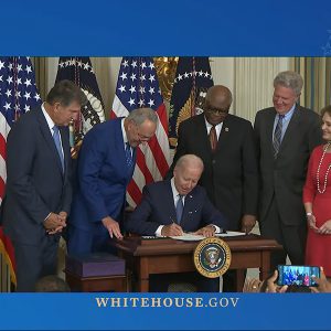 At the White House, (from left) Sen. Joe Manchin, Senate Majority Leader Chuck Schumer, Rep. Jim Clyburn, Rep. Frank Pallone and Rep. Kathy Castor look on as President Joe Biden signs the Inflation Reduction Act on Tuesday.