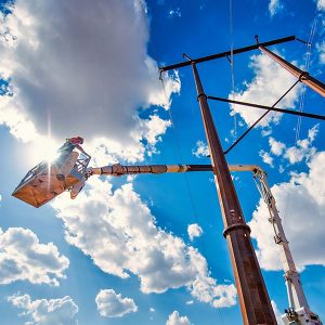 Xcel Energy lineman at transmission tower.