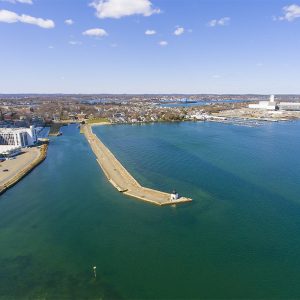 Gov. Charlie Baker hopes to create more economic benefits for Massachusetts, like the planned port development at Salem Harbor seen here, through changes to the state's offshore wind procurement process.