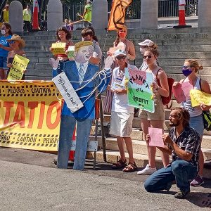 Massachusetts activists with the Sunrise Movement, Breathe Clean North Shore and more protested the state's continued funding of fossil fuel activities, such as a new natural gas plant in Peabody, at a rally outside of the state house on Saturday.