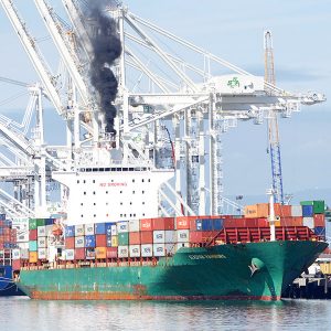 A container ship spews diesel smoke in the Port of Oakland this year.