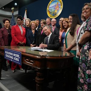 California Gov. Gavin Newsom signed infrastructure bills Monday surrounded by lawmakers.