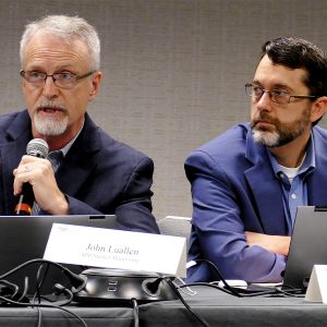 The SPP MMU's John Luallen (left) lays out the Monitor's objections to proposed accreditation policies as MMU Vice President Keith Collins listens. 