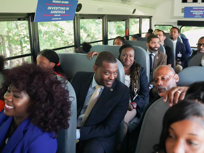 EPA Administrator Michael Regan (fourth from left) joins students and local school and government officials for a ride on a Jackson, Miss., electric school bus. The city's school district received $9.87 million in IIJA funds to buy 25 electric school buses. 