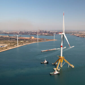 Tugboats move a floating wind turbine out of the Marseille-Fos port area in southern France en route to the Provence Grand Large pilot project.