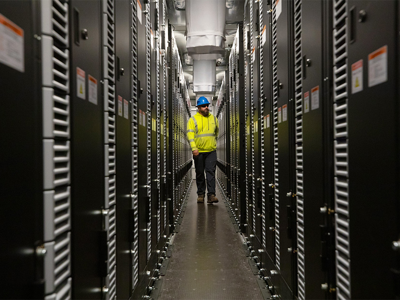 A New York Power Authority construction engineer walks through a newly commissioned battery storage unit in northern New York in 2023.