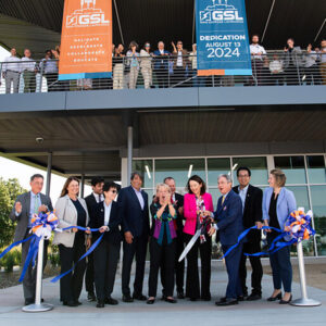 Cutting the ribbon at the Grid Storage Launchpad are (from left) Jud Virden, PNNL; Julie Turner, DOE; Jason Edwards (partially blocked), staff for Sen. Patty Murray (D-Wash); Harriet Kung, DOE Office of Science; Gene Rodrigues, DOE Office of Electricity; Geri Richmond, DOE Office of Science and Innovation; Washington State Sen. Matt Boehnke (R); Sen. Maria Cantwell (D-Wash.); Steve Ashby, PNNL; Mike Fong, Washington State Department of Commerce; and Ashley Stubbs, staff for Rep. Dan Newhouse (R-Wash).  