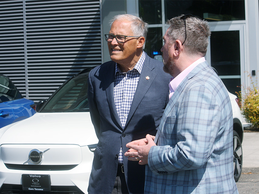 Washington Gov. Jay Inslee speaks with Jim Walen, owner of Seattle Hyundai, or Aug. 1 2024.