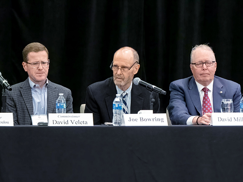 Independent Market Monitor Joe Bowring (center) speaks at the Organization of PJM States Inc. Annual Meeting on Oct. 22, as Indiana URC Commissioner David Veleta (left) and PJM Manager David Mills listen.