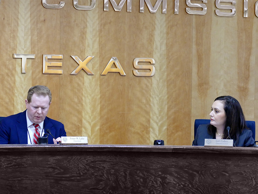 Lori Cobos with then-PUC Chair Peter Lake during a 2023 open meeting. 