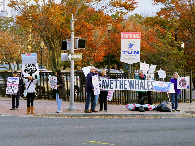 Offshore wind opponents greet people arriving at Offshore WINDPOWER in Atlantic City, N.J., on Oct. 29.