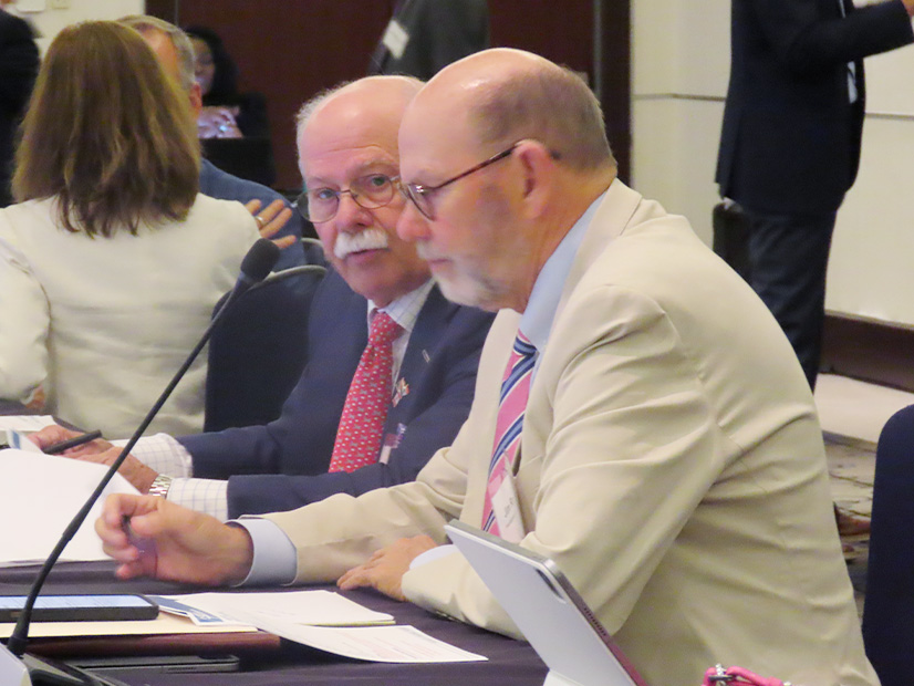 NERC Chair Kenneth DeFontes talks with CEO Jim Robb before the August board meeting in Canada. 