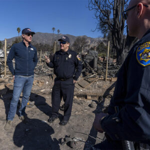 California Gov. Gavin Newsom, left, surveys damage from the Los Angeles wildfires. Newsom’s 2025/26 budget includes funding for wildfire mitigation along with a proposal to extend the state’s cap-and-trade program beyond 2030.