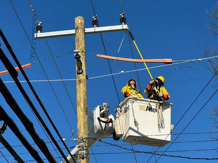 A DTE crew performs grid stability work in Wayne, Mich., in December. The Michigan utility is in line for billions in federal loan guarantees.