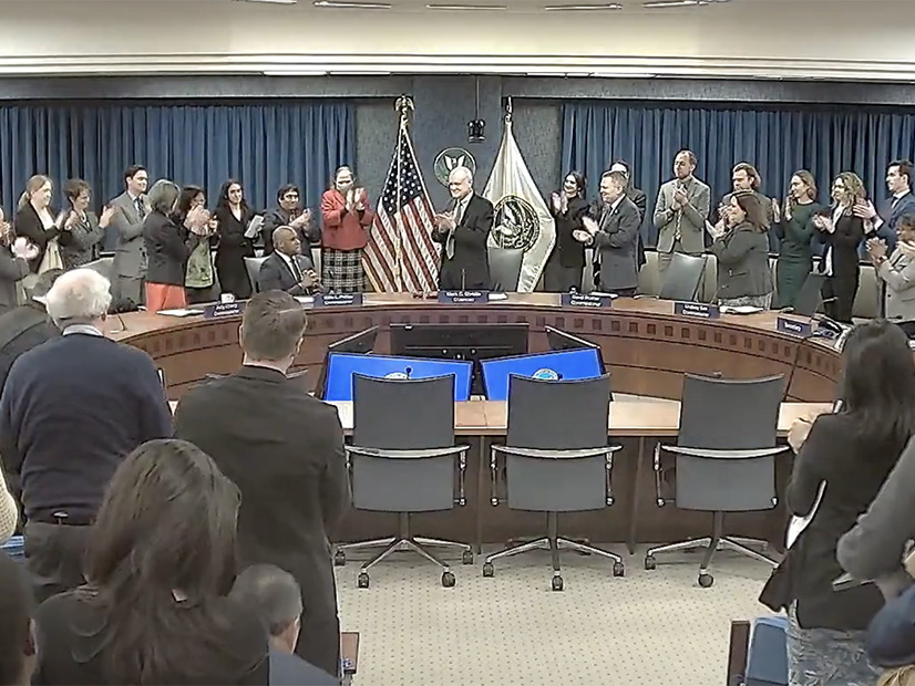 FERC Chair Mark Christie leads a round of applause for his predecessor, Commissioner Willie Phillips, at the commission's open meeting Feb. 20.